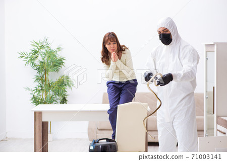 Young male contractor exterminating snakes in the flat Young male contractor exterminating snakes in the flat 71003141