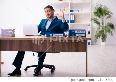Young male businessman employee working in the office Young male businessman employee working in the office 71003200