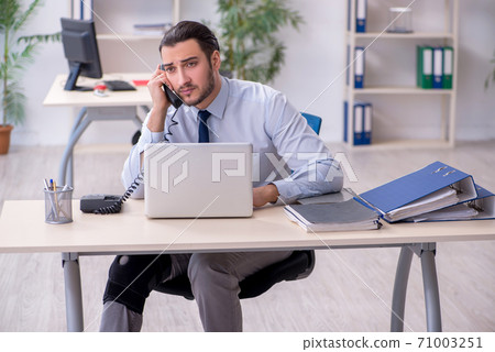 Young leg injured employee working in the office Young leg injured employee working in the office 71003251