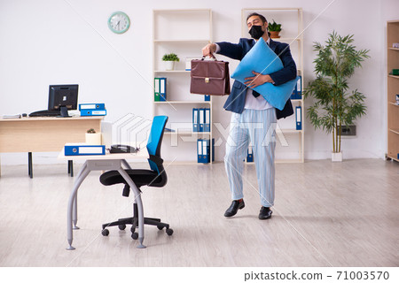 Young male employee during pandemic at workplace Young male employee during pandemic at workplace 71003570