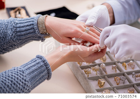 Male jeweler and female client at store Male jeweler and female client at store 71003574