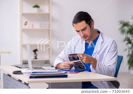 Young doctor working in the hospital 71003645