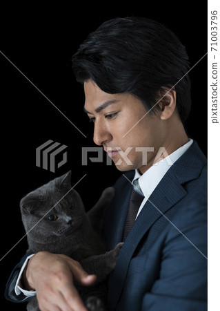 A man holding a cat A man holding a cat 71003796