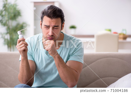 Young man suffering from sore throat 71004186