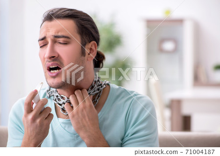 Young man suffering from sore throat Young man suffering from sore throat 71004187