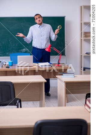 Young male teacher in front of green board Young male teacher in front of green board 71004205