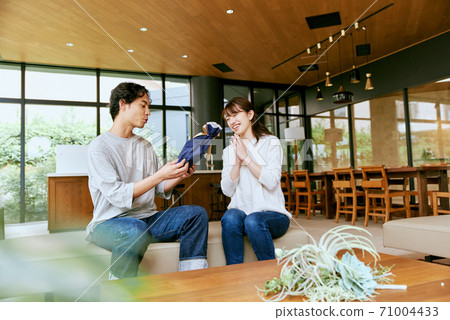 A man picking up a present A man picking up a present 71004433