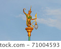 Public lighting poles adorned with statues of young women wearing ancient cultural costumes. Looks in a graceful dance. 71004593