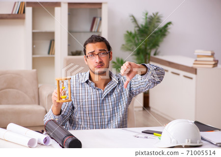 Young male architect working from house during pandemic Young male architect working from house during pandemic 71005514