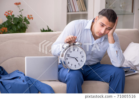 Young male employee working from the house 71005516