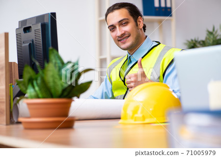 Young male architect working in the office Young male architect working in the office 71005979