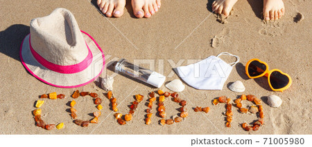 Inscription Covid-19, legs of woman and kids, mask, disinfectant liquid and vacation accessories Inscription Covid-19, legs of woman and kids, mask, disinfectant liquid and vacation accessories 71005980