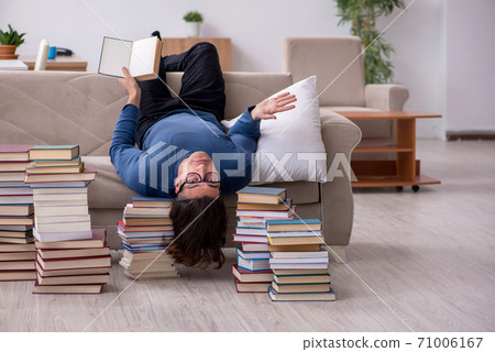 Young male student preparing for exams at home 71006167