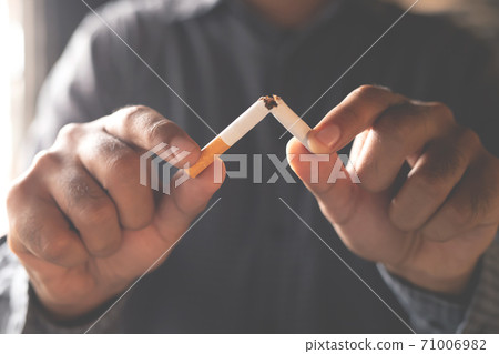 A new generation of businessman refusing cigarette A new generation of businessman refusing cigarette 71006982