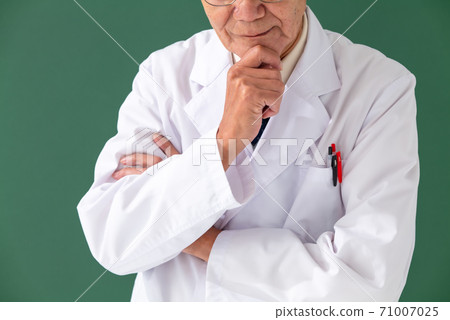A man in a white coat who is worried A man in a white coat who is worried 71007025