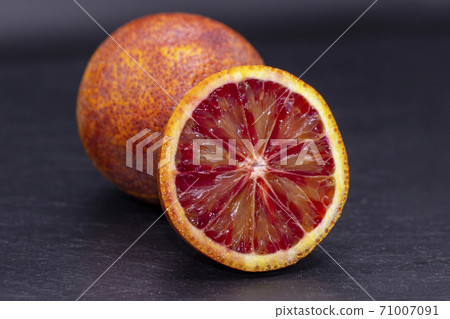 Full and two half of blood red oranges isolated on 71007091