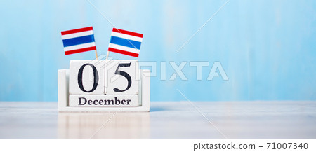 Wooden calendar of December 5th with miniature Thailand flags. Thai Nation Day and father day concepts 71007340