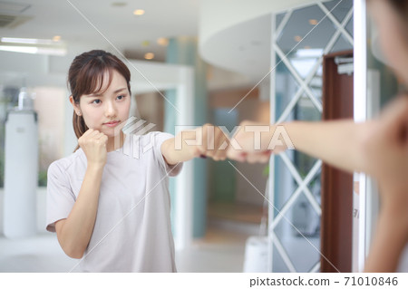 Woman doing shadow boxing Woman doing shadow boxing 71010846
