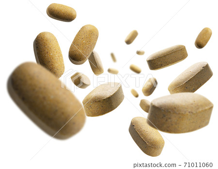 Yellow tablets levitate on a white background 71011060