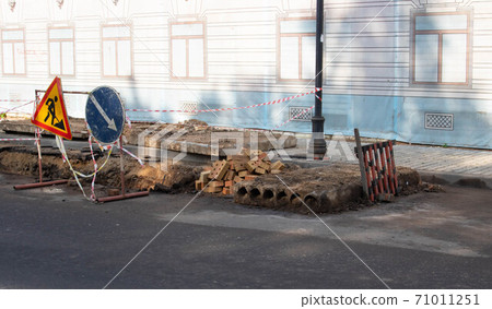 A road sign on the road indicates the path, road works, detour of a dangerous section of road, repair of the roadway 71011251