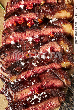 Close up of grilled Medium Rare Ribeye steak with salt cristals Close up of grilled Medium Rare Ribeye steak with salt cristals 71011769