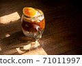 espresso shot mixed with soda on bottom in transperant glasses mug with coffee bubble topping by orange mint on wooden table in morning light refreshment stock photo 71011997
