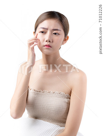 Asia woman worry about skin problem, oily skin, wrinkles, pores, acne in white background with copy space, concept cosmetology, facial treatment, beauty complexion treatment. 71012226