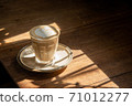 cup of latte art in coffee dish on old wood table refresh in morning light stock photo 71012277