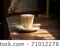 cup of latte art in coffee dish on old wood table refresh in morning light stock photo 71012278