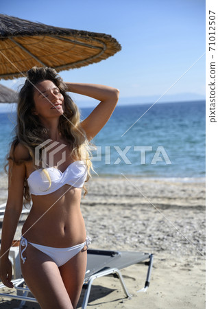 Happy young woman resting at the beach in Asprovalta Happy young woman resting at the beach in Asprovalta 71012507