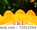 a lot of real orange cake wrap by foil and plastic on white plate and wood table stock photo 71012569