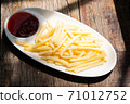home made french fry on white plate with pepper half ketchup on wood table stock photo 71012752