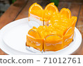a lot of real orange cake wrap by foil and plastic on white plate and wood table stock photo 71012761