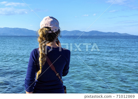 Woman shooting on small camera blue sea in Nea Roda 71012869