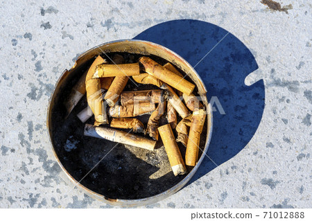 Close up of smoked cigarettes with orange filter - Stock Photo [71012888]
