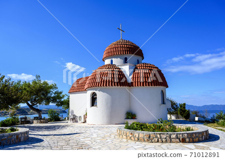 Orange and white church on hills of Nea Roda village and port 71012891