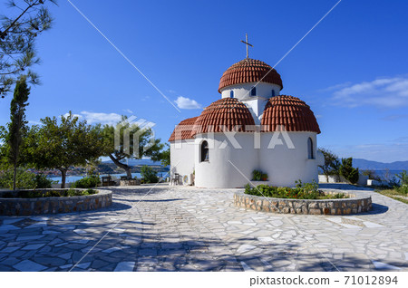 Orange and white church on hills of Nea Roda village and port 71012894