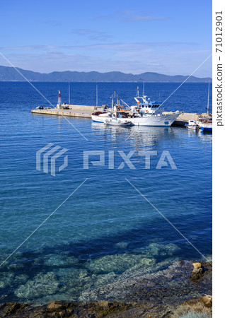 Boats in the port of Nea Roda on blue sea water 71012901
