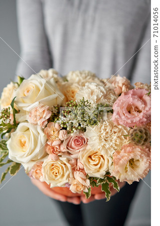 Flowers arrangement in pumpkin on the white table. Fresh cut flowers for decoration home. European floral shop. Delivery fresh cut flower. Flowers arrangement in pumpkin on the white table. Fresh cut flowers for decoration home. European floral shop. Delivery fresh cut flower. 71014056