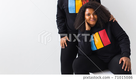 Happy African American woman and her friend on white background with copy space. 71015086