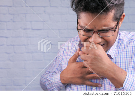 sick man with sneezes and coughs 71015105