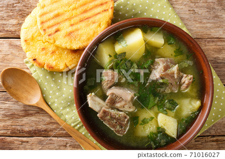 Colombian beef rib soup with potatoes and herbs Caldo de costilla close-up in a bowl. Horizontal top view Colombian beef rib soup with potatoes and herbs Caldo de costilla close-up in a bowl. Horizontal top view 71016027