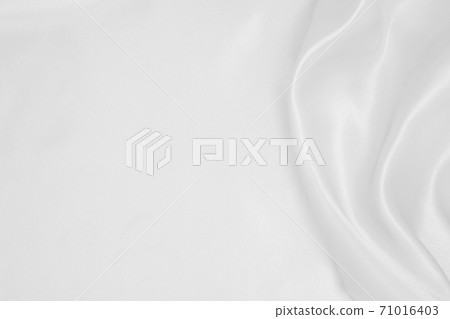 Smooth elegant white silk or satin luxury cloth texture as wedding background. Luxurious background design Smooth elegant white silk or satin luxury cloth texture as wedding background. Luxurious background design 71016403