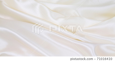 Smooth elegant white silk or satin luxury cloth texture as wedding background. Luxurious background design Smooth elegant white silk or satin luxury cloth texture as wedding background. Luxurious background design 71016410