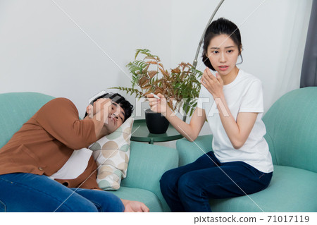 A man who is sick and has a fever. Busy body temperature. 71017119