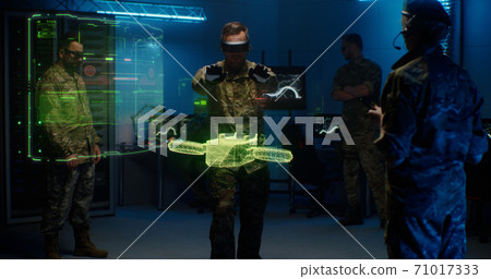 Military men controlling holographic model of drone 71017333