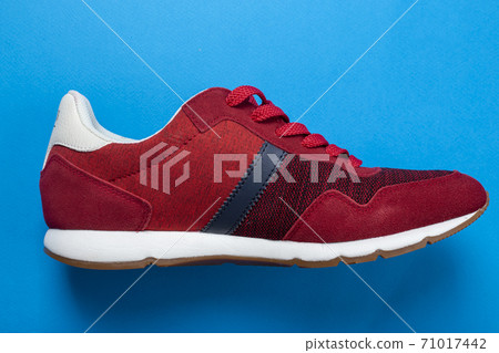 Stylish red sneakers on color background Stylish red sneakers on color background 71017442