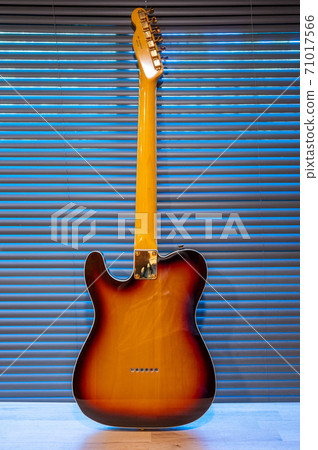 Sunburst electric guitar telecaster shape (gold hardware) on woden table in the room. businoess and music concept. Wallpaper or background Sunburst electric guitar telecaster shape (gold hardware) on woden table in the room. businoess and music concept. Wallpaper or background 71017566