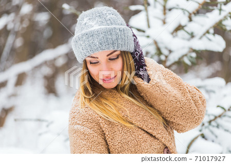 Attractive young woman in winter time outdoor. Snow, holidays and season concept. 71017927