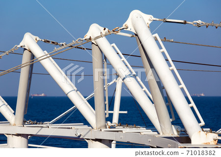 deck tensioners close-up of mounts and tensioning cables of the structure against a blue sky and sea during the day, nobody. 71018382
